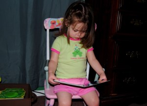 Erin reading a book in her new rocking chair
